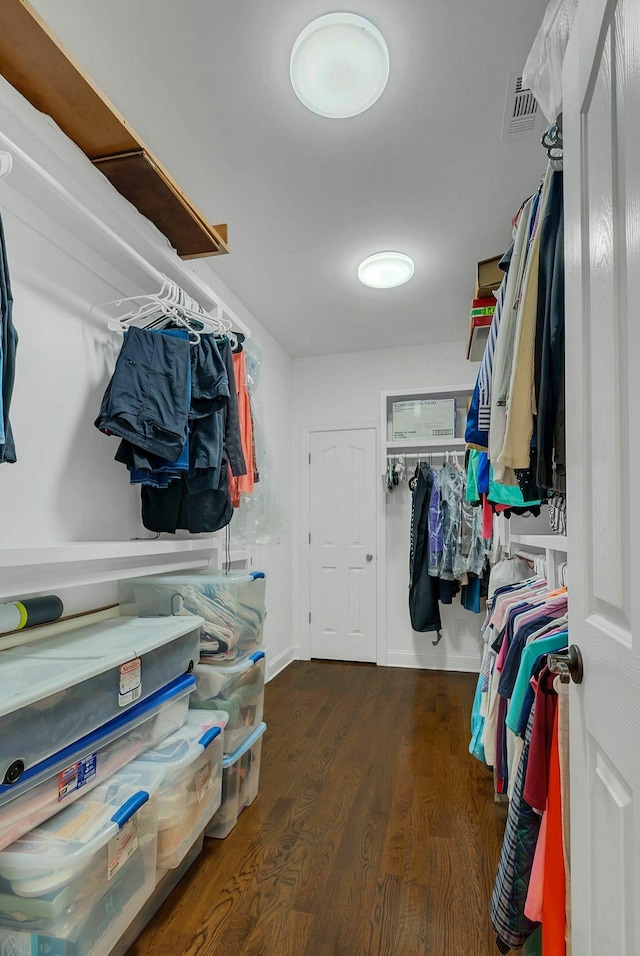 spacious closet with dark hardwood / wood-style floors