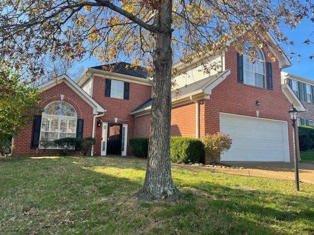 view of property featuring a garage and a front lawn