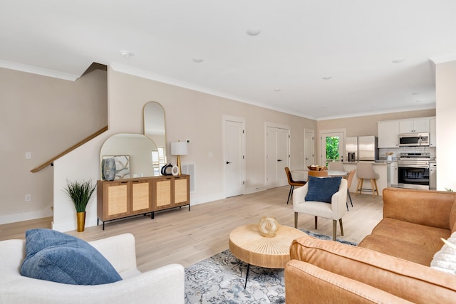 living room featuring light hardwood / wood-style floors and ornamental molding