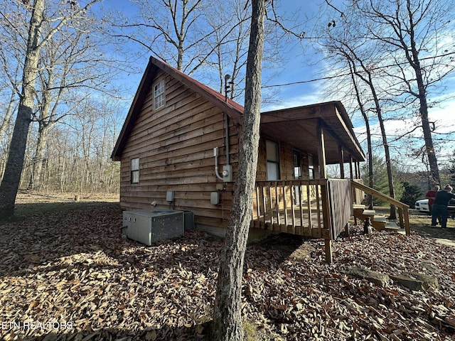 view of home's exterior with a porch and central AC