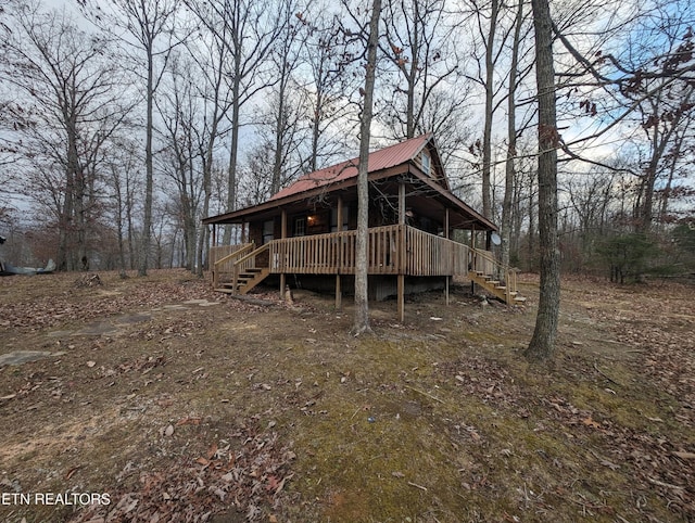 rear view of house featuring a deck