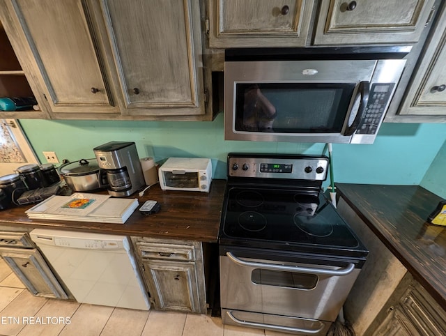 kitchen featuring light tile patterned floors and appliances with stainless steel finishes