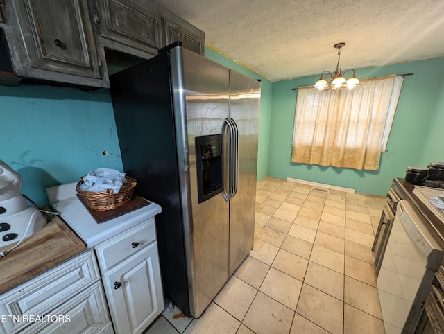 kitchen featuring decorative light fixtures, light tile patterned floors, a textured ceiling, a notable chandelier, and stainless steel fridge with ice dispenser