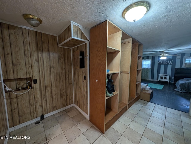 interior space with light tile patterned floors and ceiling fan