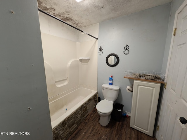 bathroom featuring a textured ceiling, toilet, shower / bathtub combination, and hardwood / wood-style flooring