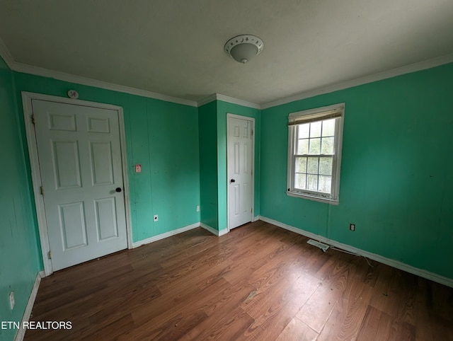 unfurnished bedroom featuring hardwood / wood-style flooring and ornamental molding