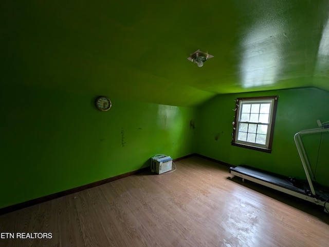 bonus room with light hardwood / wood-style flooring and vaulted ceiling