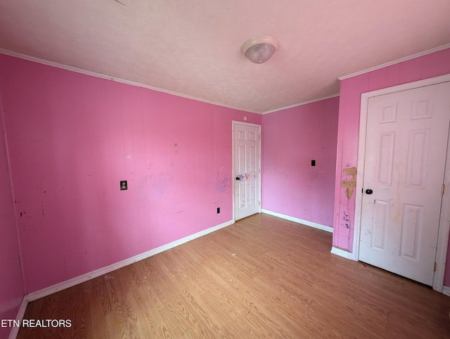 unfurnished room with hardwood / wood-style floors and ornamental molding