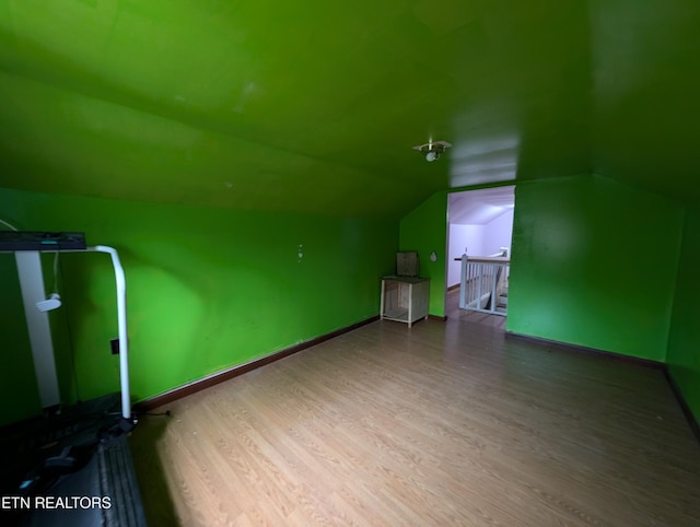 bonus room with wood-type flooring and lofted ceiling