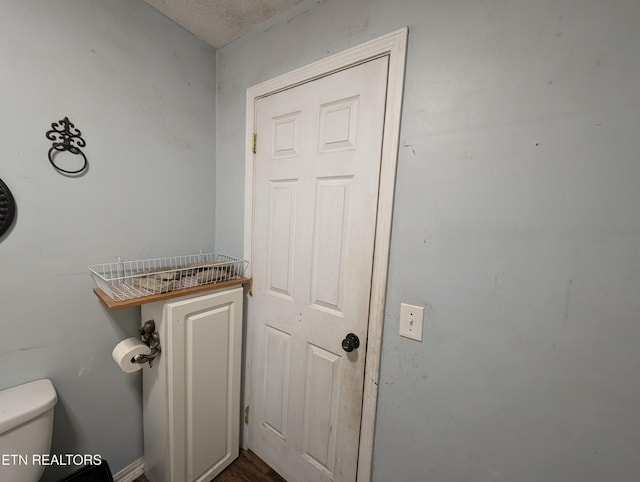 bathroom featuring a textured ceiling and toilet