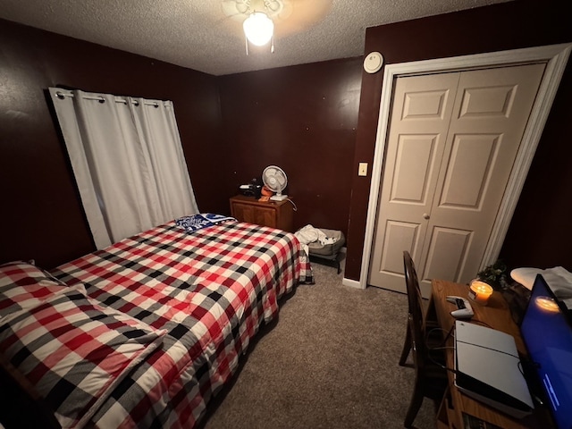 carpeted bedroom featuring ceiling fan, a closet, and a textured ceiling