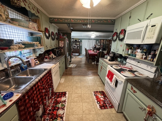 kitchen featuring ornamental molding, a textured ceiling, white appliances, sink, and light hardwood / wood-style flooring