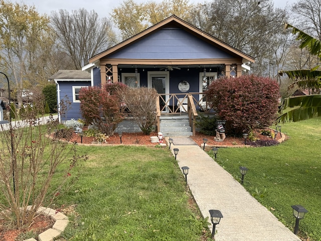 bungalow-style home featuring a front lawn and covered porch