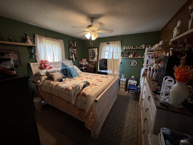 bedroom with multiple windows, ceiling fan, dark carpet, and a textured ceiling