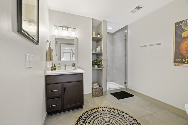 bathroom featuring tile patterned flooring, vanity, and walk in shower