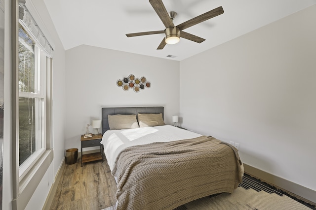 bedroom with hardwood / wood-style flooring, ceiling fan, and lofted ceiling