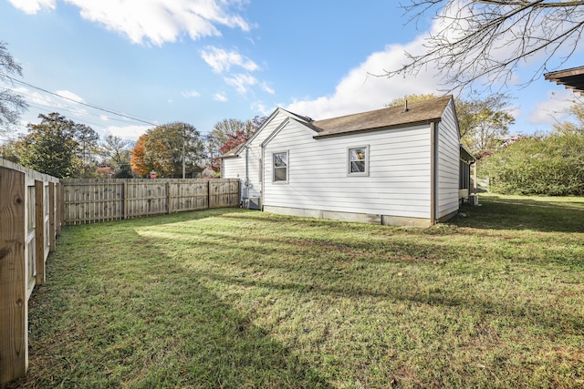 rear view of house featuring a lawn