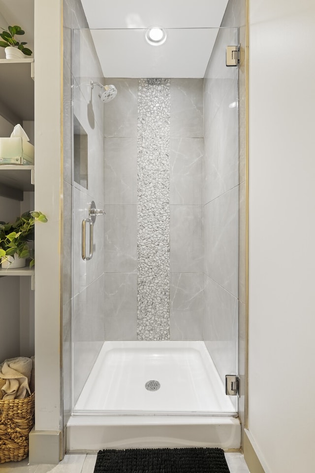 bathroom with tile patterned floors and an enclosed shower