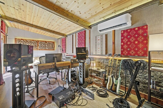 office area featuring wood-type flooring, lofted ceiling with beams, an AC wall unit, and wooden ceiling