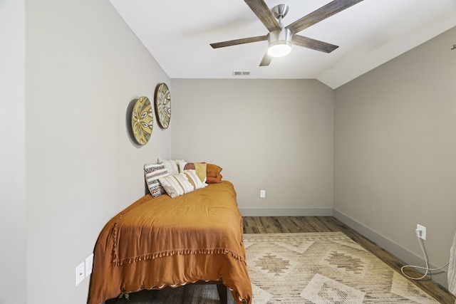 bedroom featuring ceiling fan, vaulted ceiling, and hardwood / wood-style flooring