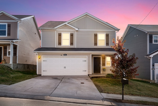 front of property with a lawn and a garage