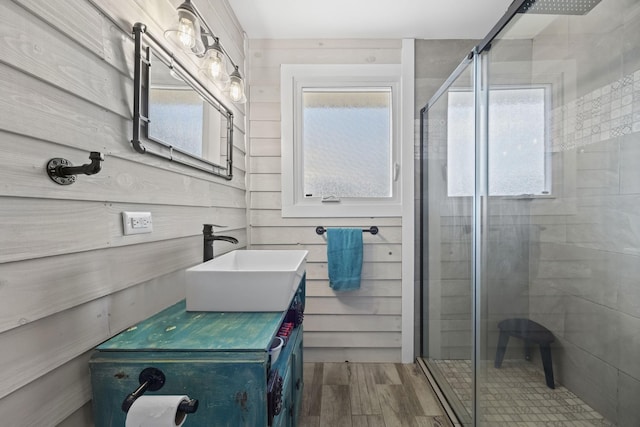 bathroom featuring hardwood / wood-style floors, vanity, and walk in shower