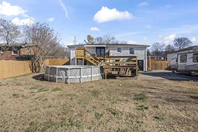 rear view of house featuring a pool side deck