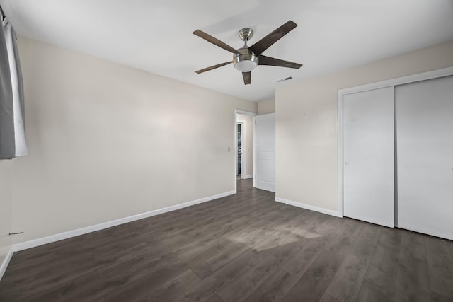 unfurnished bedroom featuring a closet, ceiling fan, and dark hardwood / wood-style floors