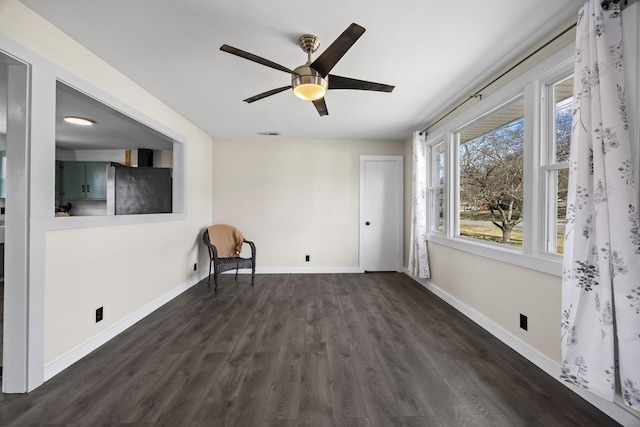 unfurnished room featuring ceiling fan and dark wood-type flooring