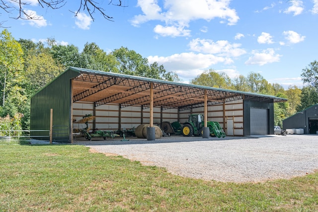 view of outbuilding with a yard and a garage