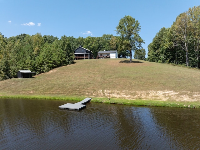 view of dock featuring a yard and a water view