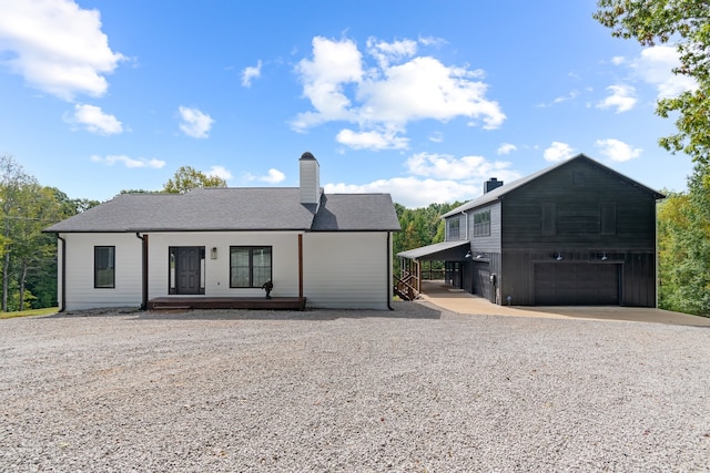 view of front of house with covered porch, a garage, and a carport