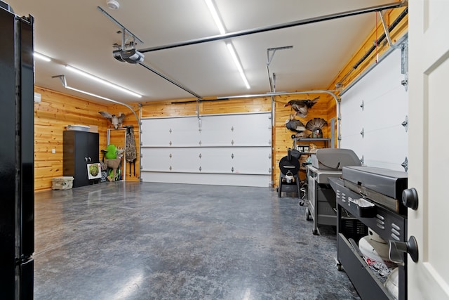 garage featuring wooden walls and a garage door opener