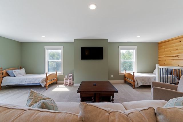 carpeted bedroom featuring multiple windows