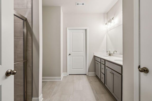 bathroom with vanity and an enclosed shower