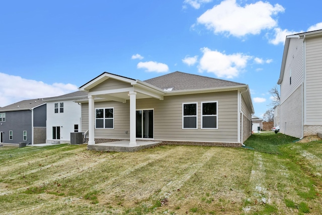 back of property featuring a yard, a patio, and central AC