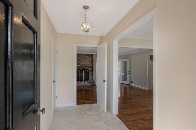 518 Hemingway Dr, Columbia, TN 38401 - entryway with a chandelier, light marble finish flooring, and a fireplace