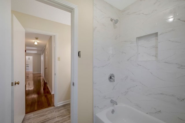 bathroom featuring hardwood / wood-style floors and tiled shower / bath