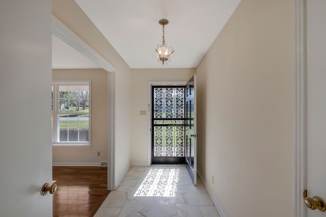 foyer entrance with an inviting chandelier