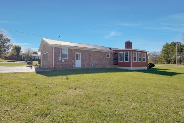 back of house with a lawn