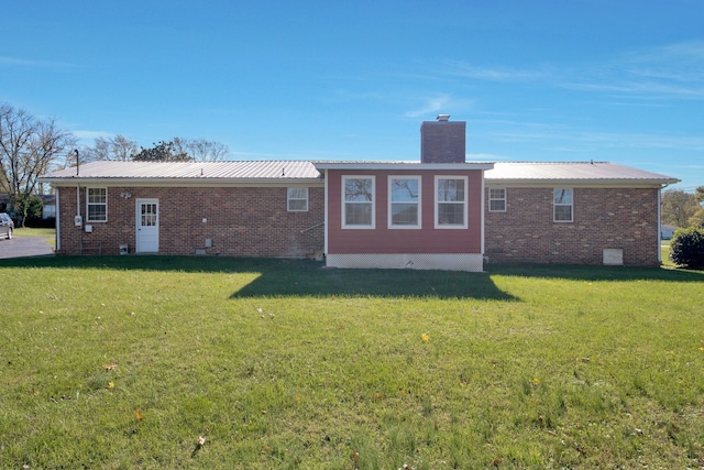 rear view of property featuring a yard