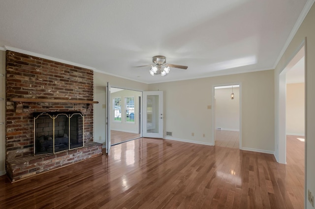 518 Hemingway Dr, Columbia, TN 38401 - unfurnished living room with a ceiling fan, wood finished floors, ornamental molding, and a brick fireplace