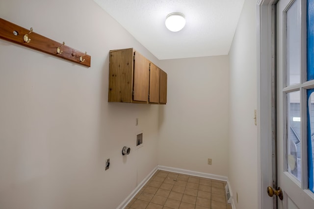 laundry area featuring cabinets, hookup for a washing machine, hookup for an electric dryer, a textured ceiling, and light tile patterned floors