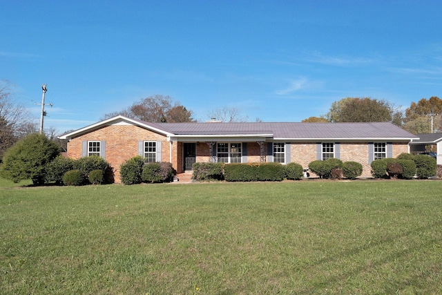 518 Hemingway Dr, Columbia, TN 38401 - ranch-style house featuring brick siding, a front yard, and a metal roof
