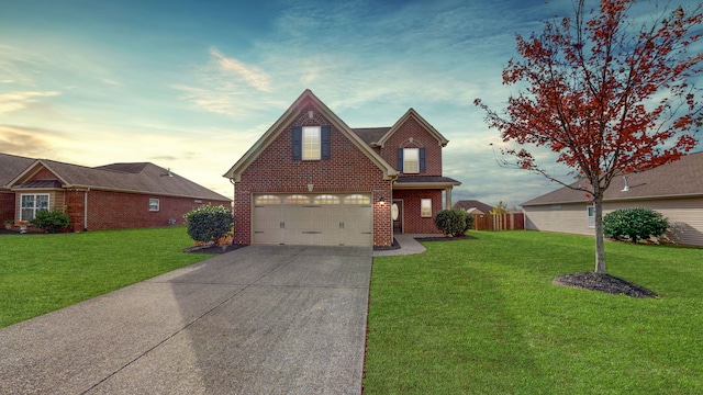 view of front of house with a yard and a garage