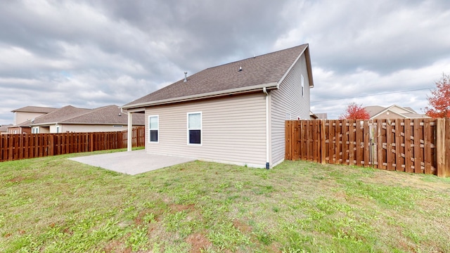 rear view of property featuring a patio area and a yard