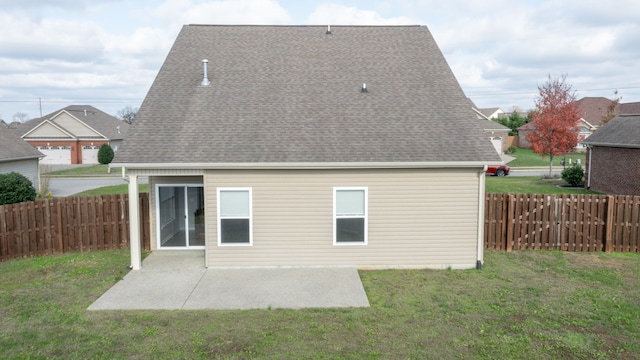 back of property with a patio area and a lawn