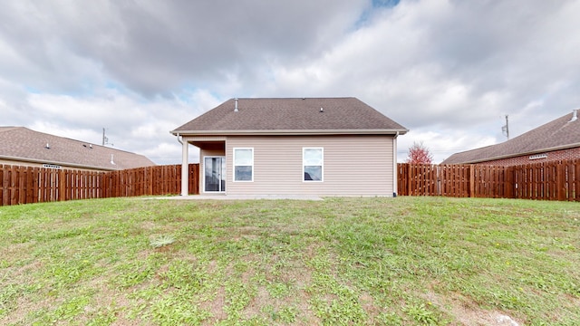 rear view of property with a yard