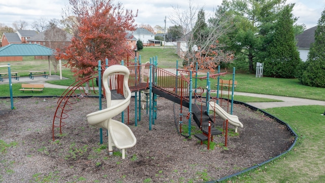 view of jungle gym with a lawn