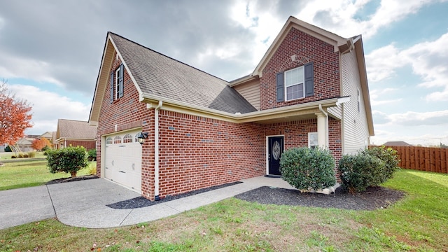 view of property with a front lawn and a garage